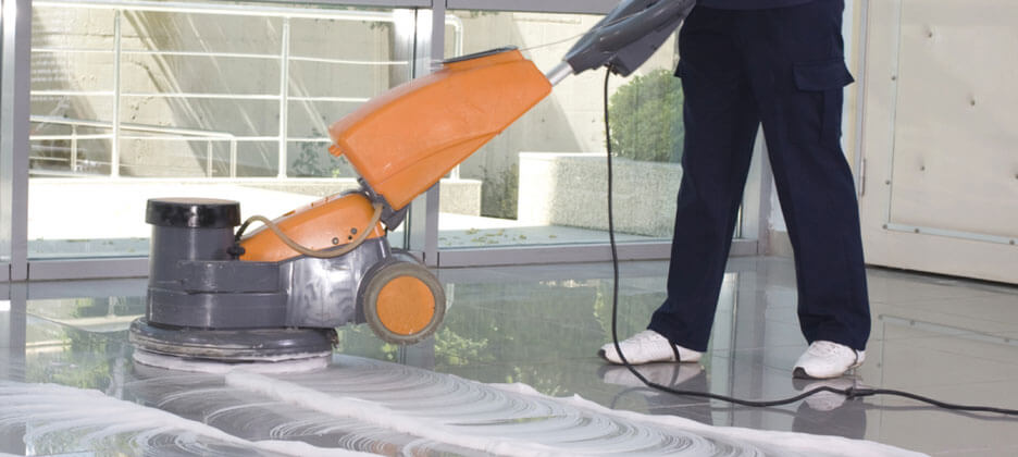 janitor cleaning floor scrubber machine to clean the floor